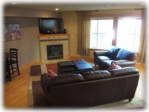 Great room with leather sofa and loveseat , and even a gas fireplace!