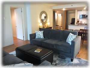 Looking across living area to kitchen and den area